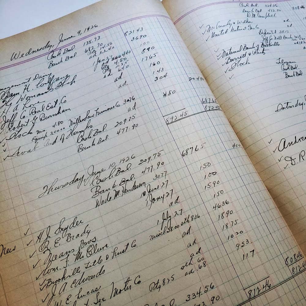 An open handwritten ledger from 1926, ink columns of cash balances.