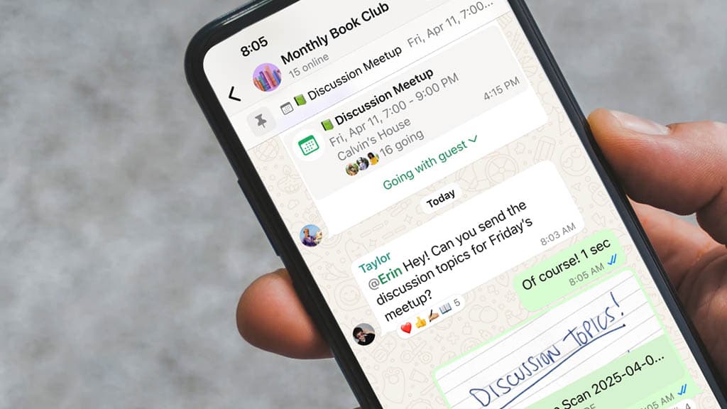 A hand holding a phone open to a WhatsApp chat, mid-conversation.
